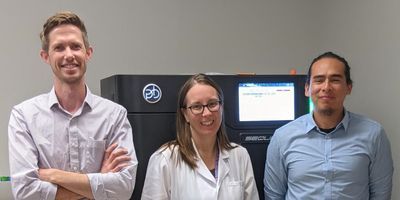 Corey Watson, Ph.D., Melissa Smith, Ph.D., and Oscar Rodriguez, Ph.D., with the Pacific Biosciences Sequel IIe DNA sequencing system, housed in the University of Louisville Sequencing Technology Center.