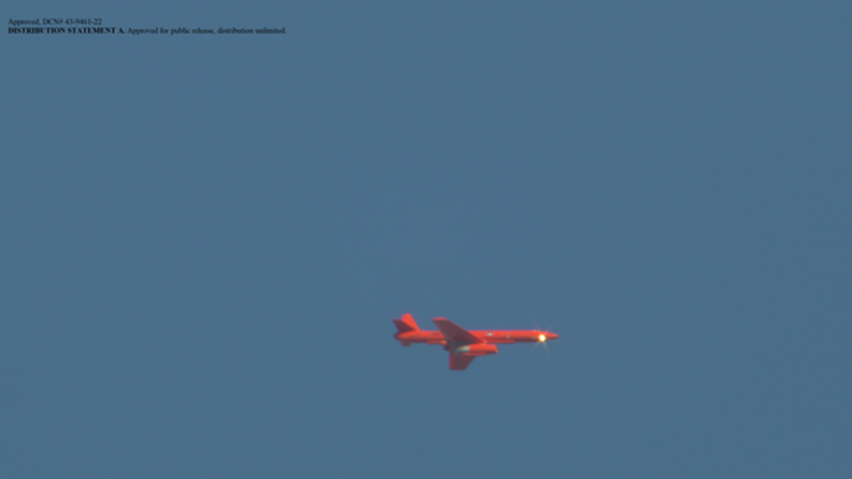red drone flying in sky red drone flying in sky