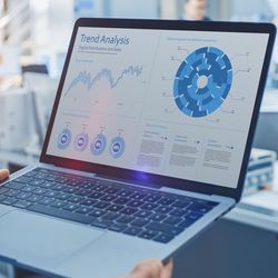 Scientist uses a computer with charts visualizing data on it
