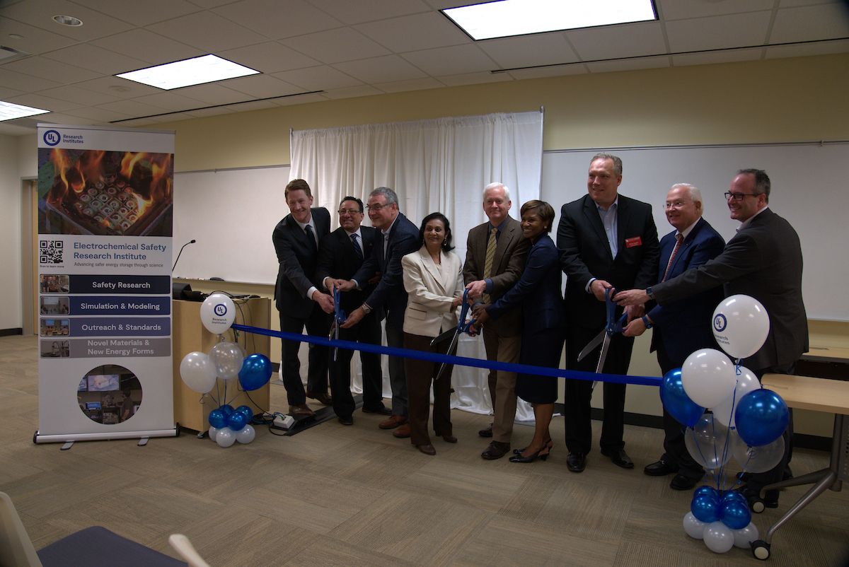 Group of people cut a ribbon at a new laboratory opening