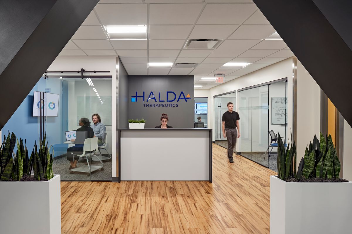 The reception area of Halda Therapeutics, featuring glass-walled conference rooms and a reception desk